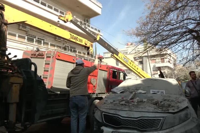 Car covered in building debris 