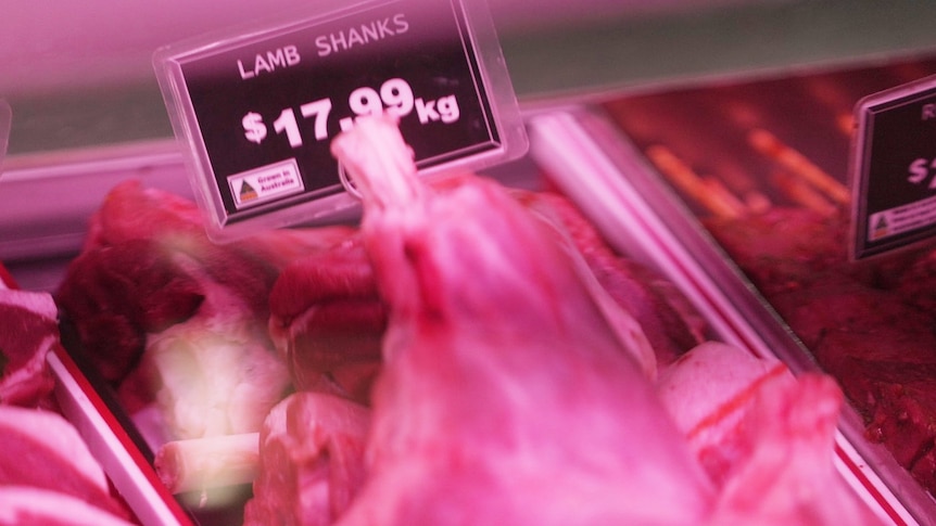 a tray of lamb shanks in a butcher's display