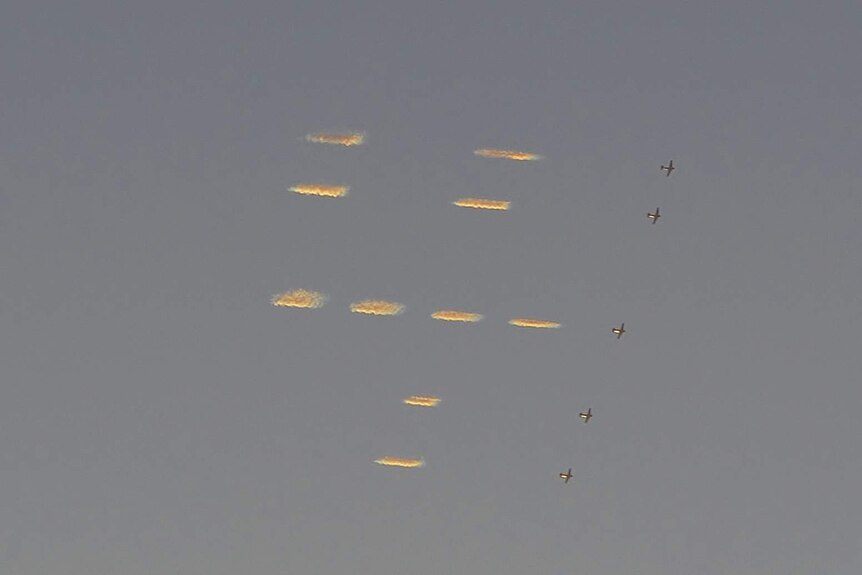 Five planes 'skytype' the number four in a dot matrix style in the sky above New York City.