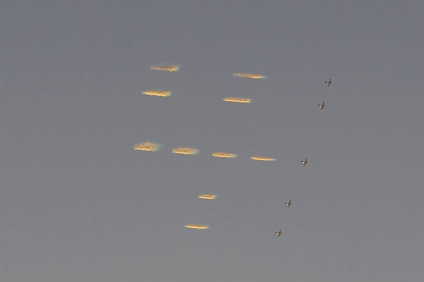 Five planes 'skytype' the number four in a dot matrix style in the sky above New York City.