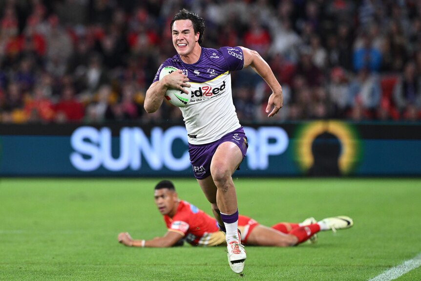 Melbourne Storm's Jack Howarth runs with the ball in hand during an NRL game.