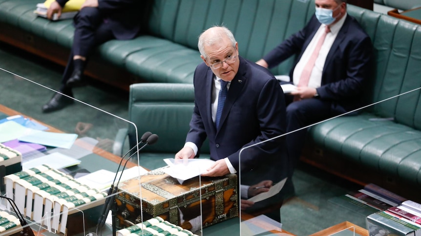 Prime Minister Scott Morrison stands in the House of Representatives behind perspex on August 23, 2021.