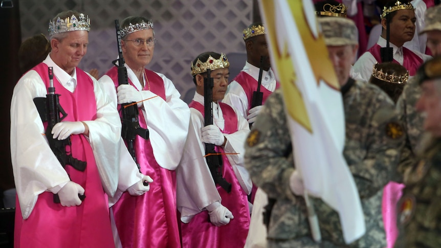 Worshippers wear crowns and celebrate their weapons at the blessing ceremony.