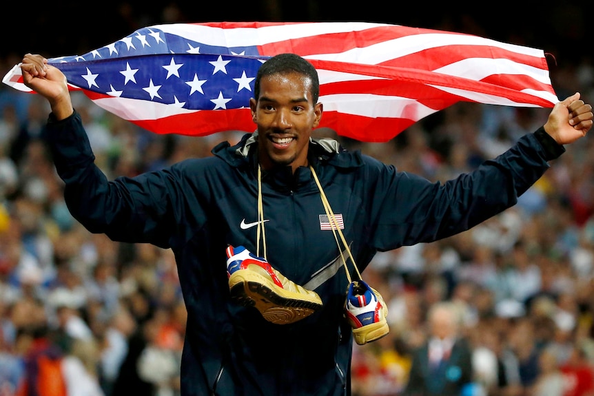 Christian Taylor celebrates after winning the gold medal in the men's triple jump.