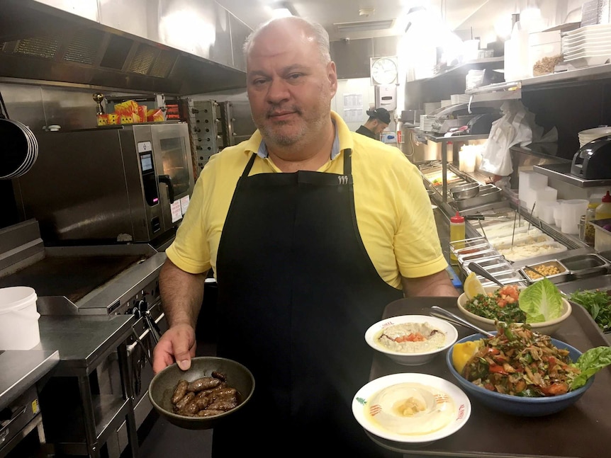 Chef and Restaurateur Faysal El-Abd in his kitchen with a range of Lebanese dishes.