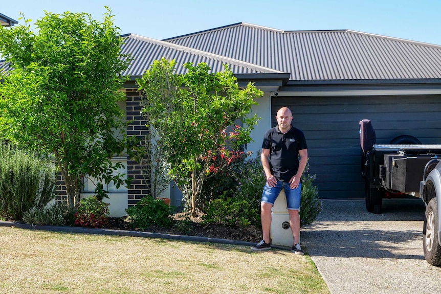 Matt Emptage sitting in front of his Gold Coast home, he is worried his landlord could evict him.