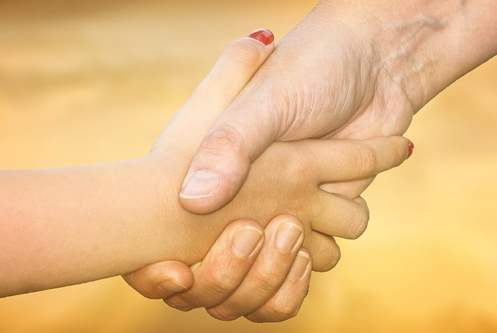 Male and female hands shaking, generic image.