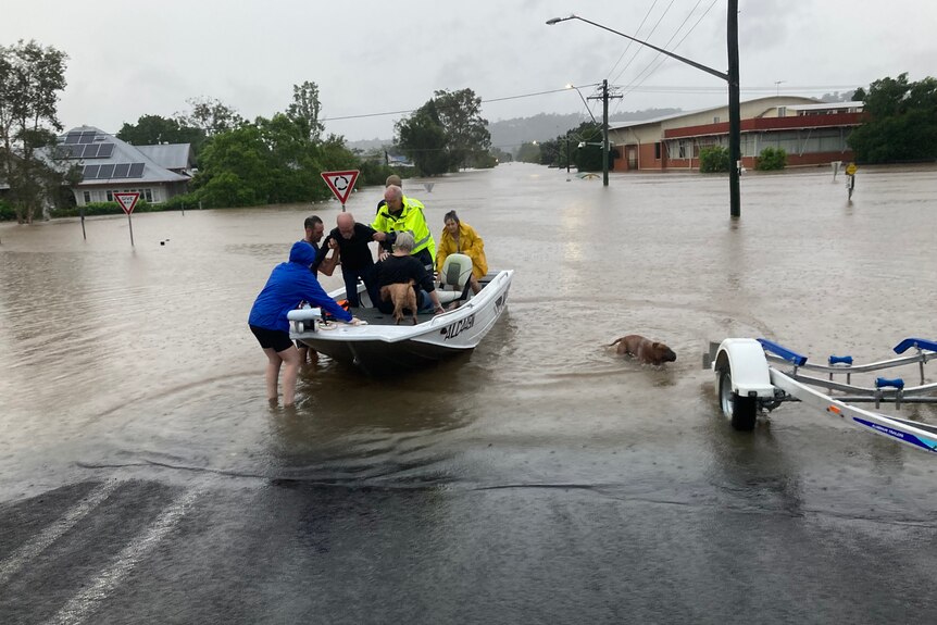 boat with people in it, in flood waters