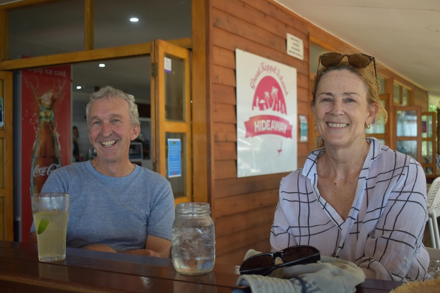 A man and a woman sitting at a bar