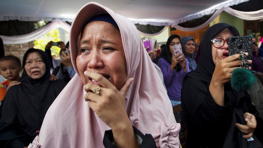 A family member cries at the funeral of Jannatun Cintya Dewi, a passenger of Lion Air flight JT610.