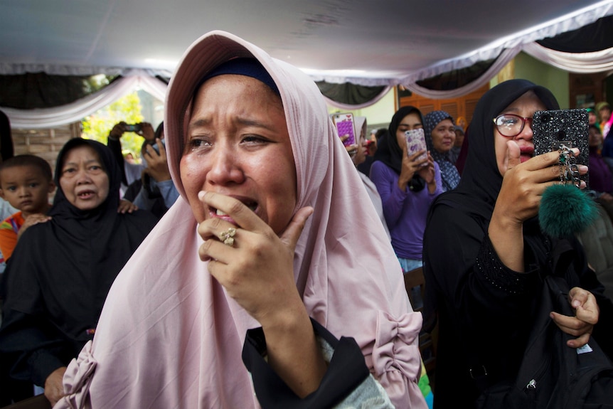 A family member cries at the funeral of Jannatun Cintya Dewi, a passenger of Lion Air flight JT610.