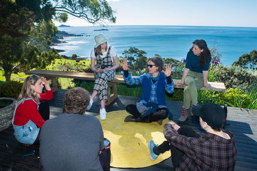 Big hArt planning team workshopping ideas in the sun, overlooking coastline