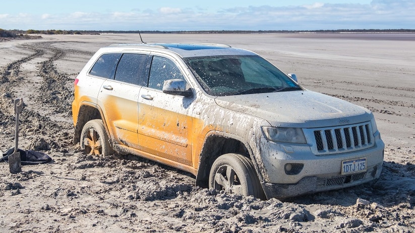 A silver car is bogged