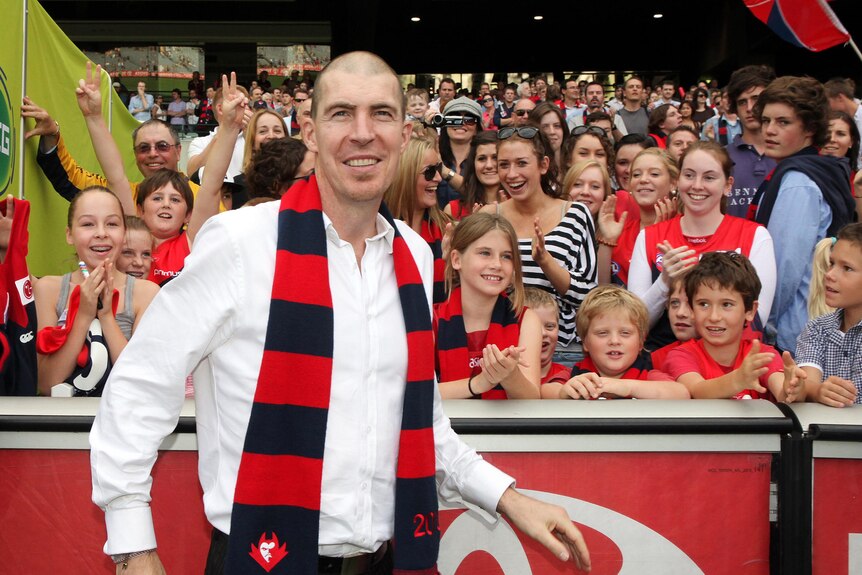 Jim Stynes celebrates with Demons fans after Melbourne win.