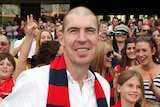 Jim Stynes celebrates with Demons fans after Melbourne win.