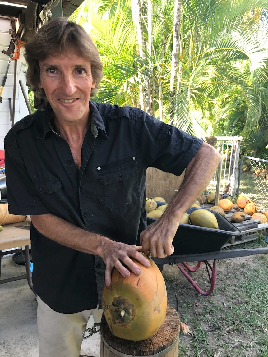 Paul Richardson demonstrates how to use his coco-tap on a coconut.