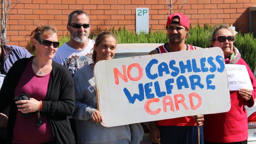 Protesters hold signs against the cashless welfare card in Ceduna in South Australia.