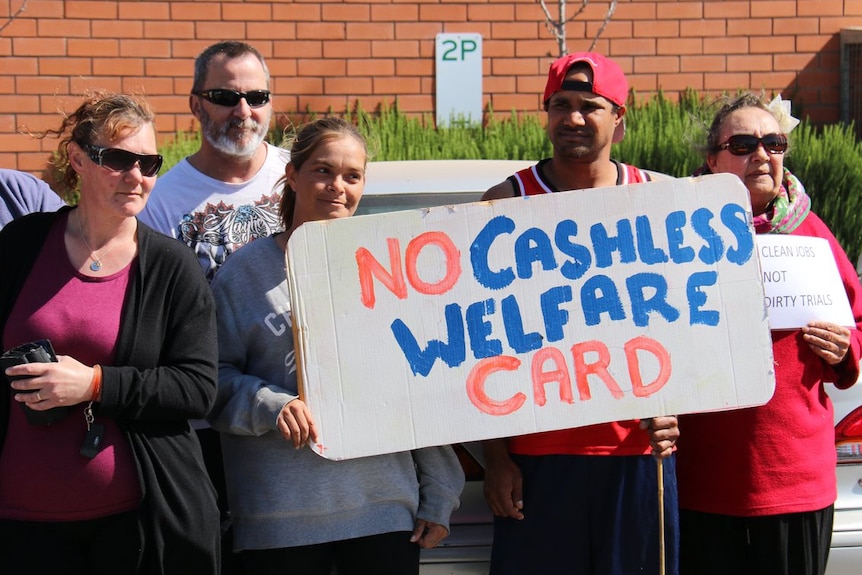 Protesters hold signs against the cashless welfare card in Ceduna in South Australia.