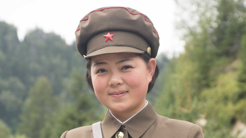 A woman wearing North Korean uniform.