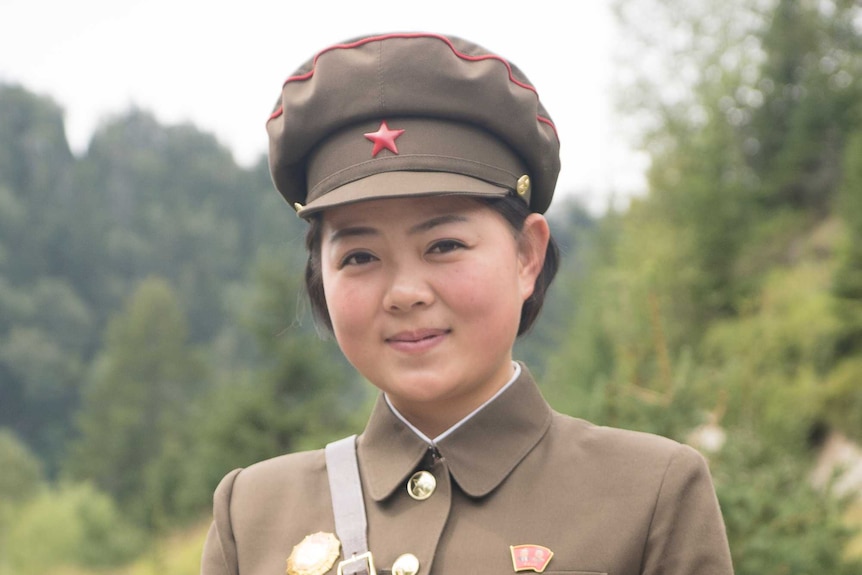 A woman wearing North Korean uniform.