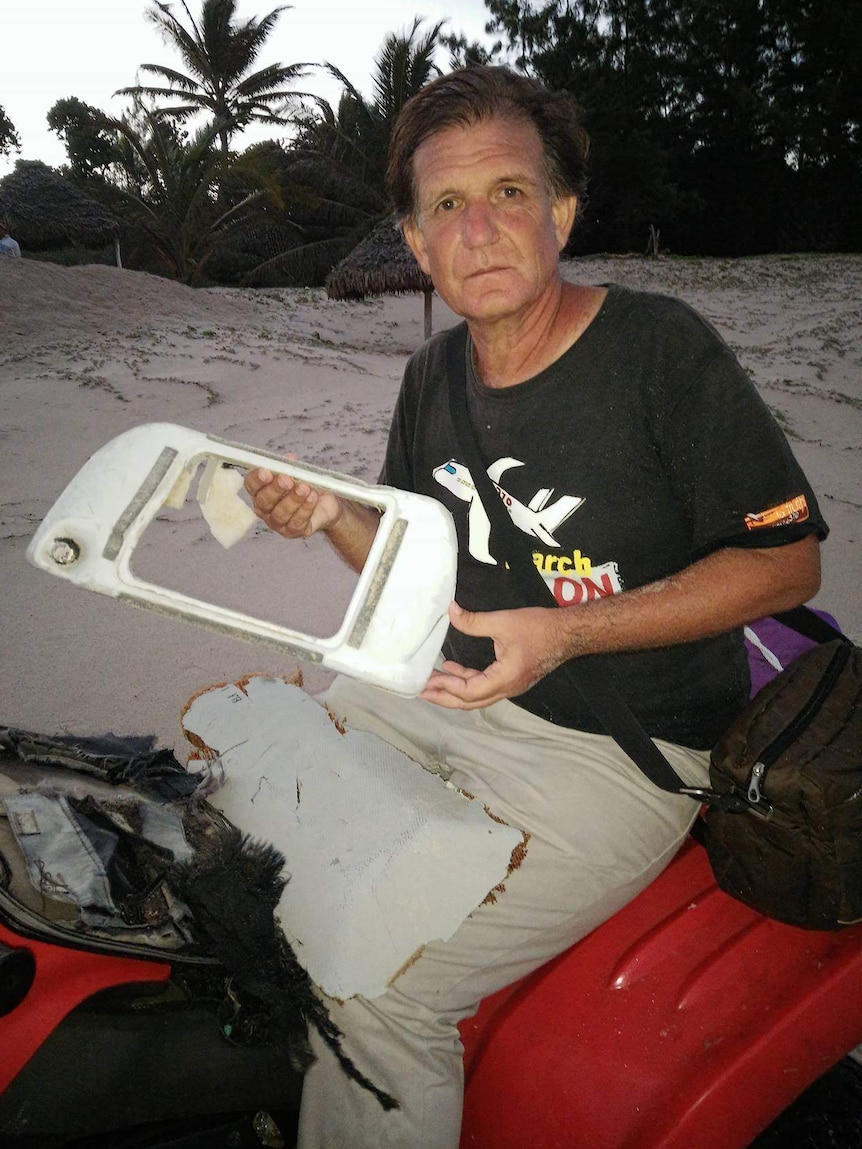 Blaine Gibson holding a television monitor.