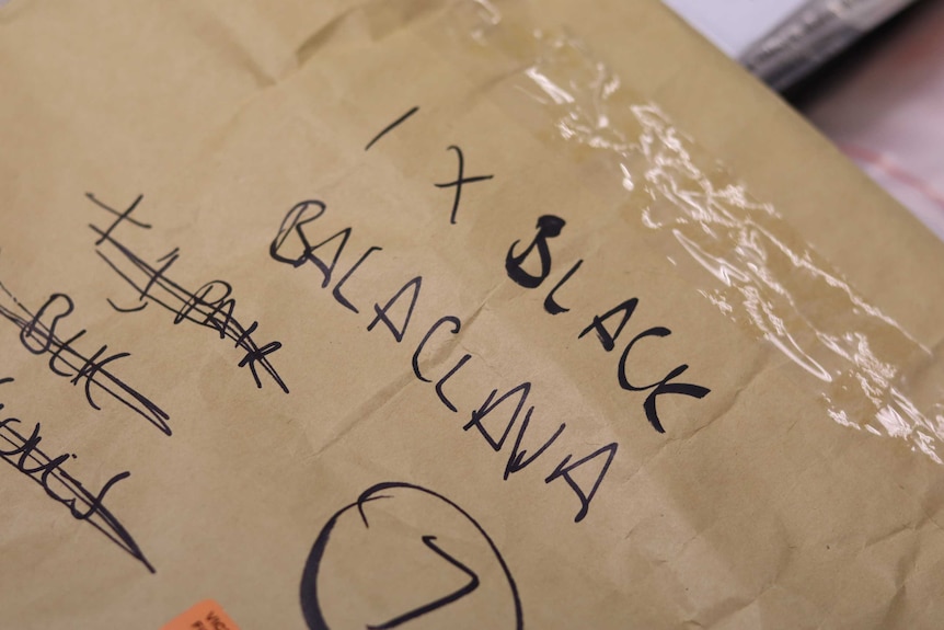 A box labelled in black pen reads 1x black balaclava