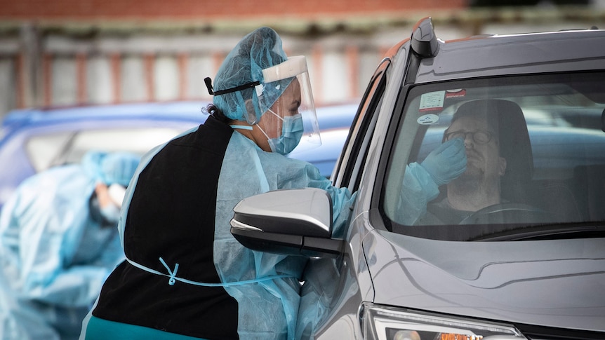 A driver has a COVID-19 test at a drive through clinic in Auckland