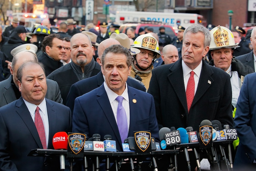 New York mayor Billl de Blasio looks on as New York governor Andrew Cuomo holds a press conference.