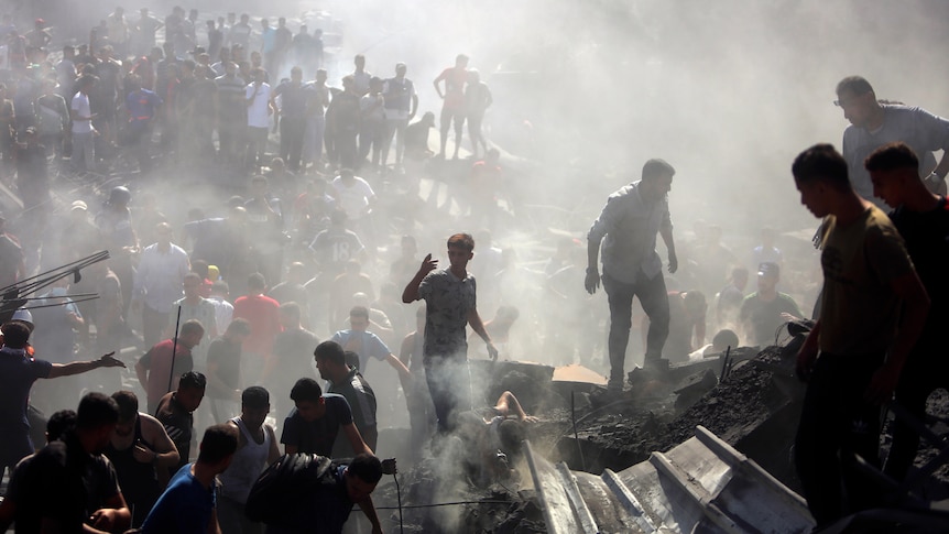 Palestinians inspect the rubble of destroyed buildings following Israeli airstrikes on the town of Khan Younis.