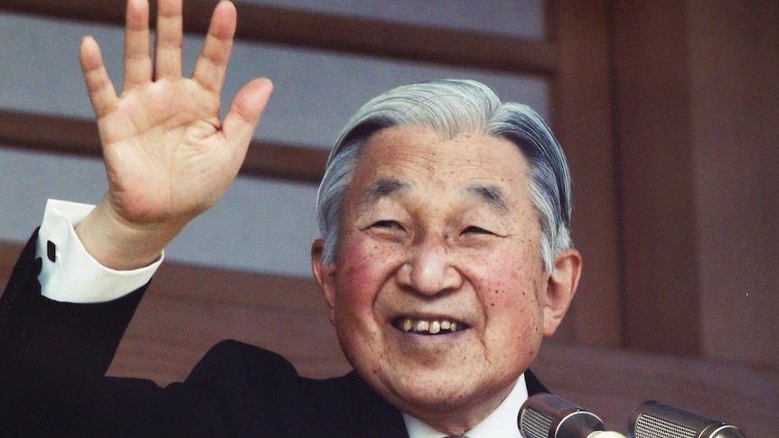 Japan's Emperor Akihito waves to well-wishers from a bullet-proofed balcony of the Imperial Palace in Tokyo.