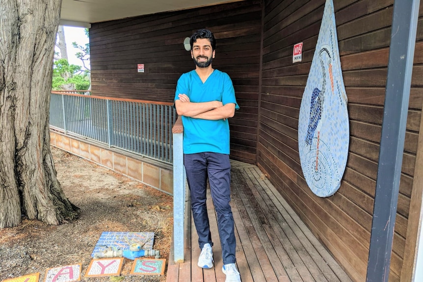 A man standing next to a tree