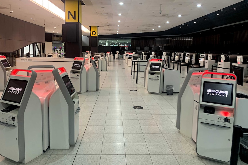 Check-in kiosks at an empty Melbourne Airport terminal.