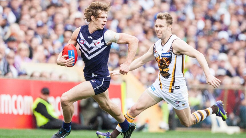 Fremantle's Nat Fyfe runs with the ball against Hawthorn at Subiaco Oval