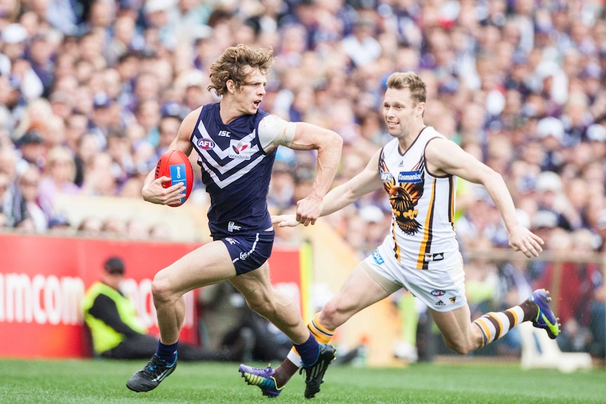 Fremantle's Nat Fyfe runs with the ball against Hawthorn at Subiaco Oval in August 2014.