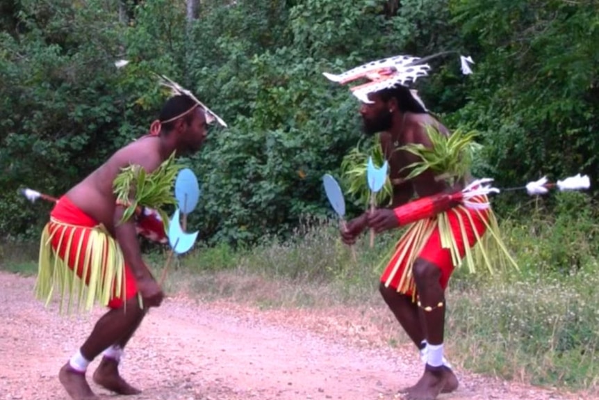 Two Mer Island men dancing in traditional costume
