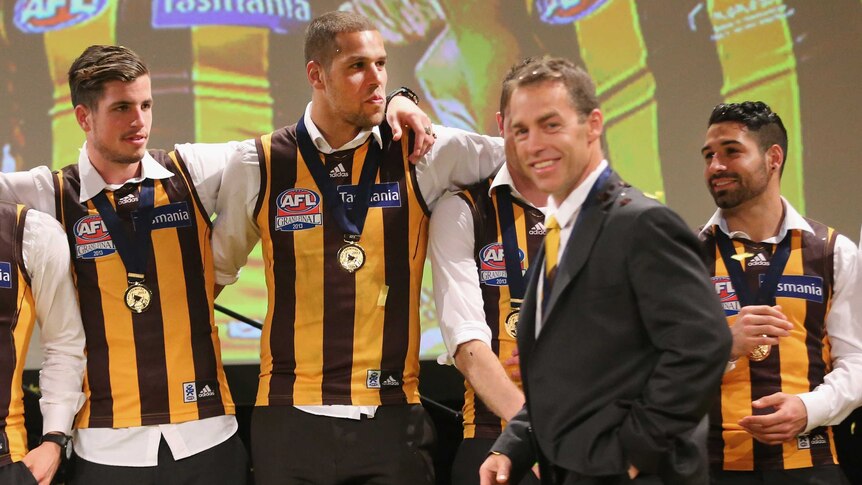 Lance Franklin looks on as Hawks coach Alastair Clarkson walks on stage during post match function.