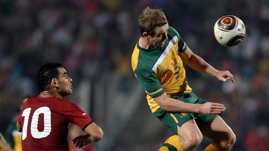 Australia's David Carney heads the ball in front of Egypt's Ahmed Abdul Malek in Cairo.