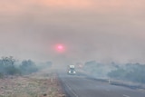 a truck on a highway covered in smoke