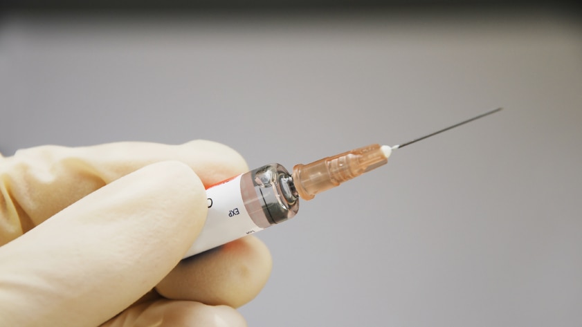 A person holding a syringe
