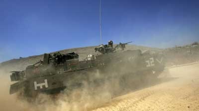 Israeli armoured personnel carriers have crossed the border into southern Lebanon.