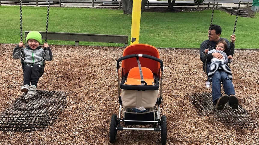 Mark Tamhane on the swings with two of his children for a story about professional dads