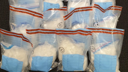 A pile of bags containing a white powder