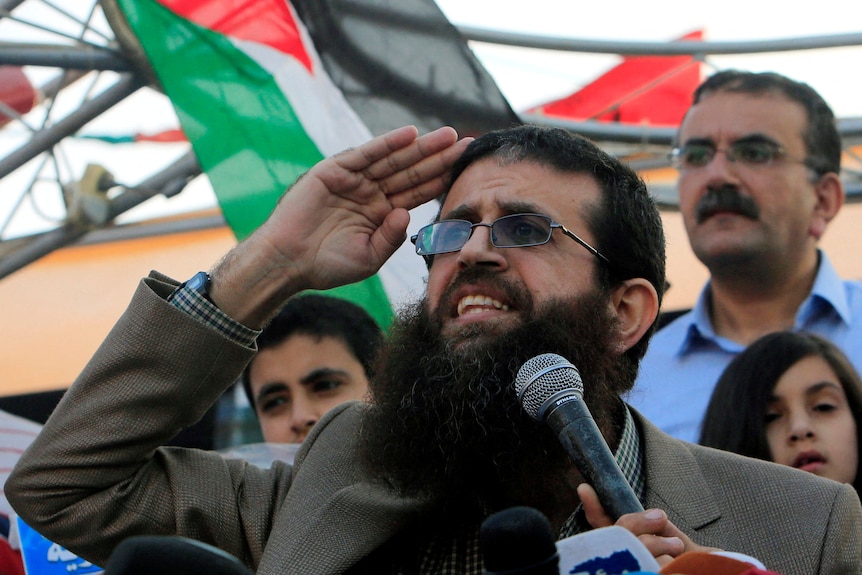 Palestinian Islamic Jihad leader Khader Adnan gestures as he speaks during a rally.