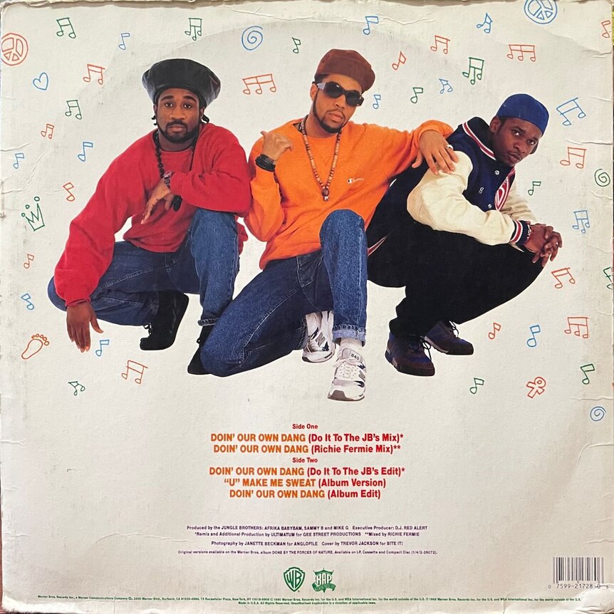 Three men crouch against a white background, all wearing 80s 'street' clothing.