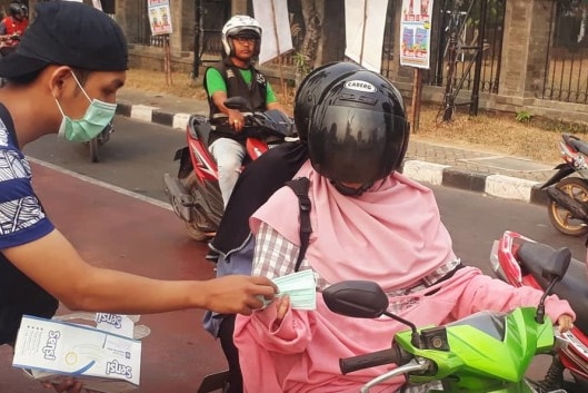 Residents sharing facemask in Jambi