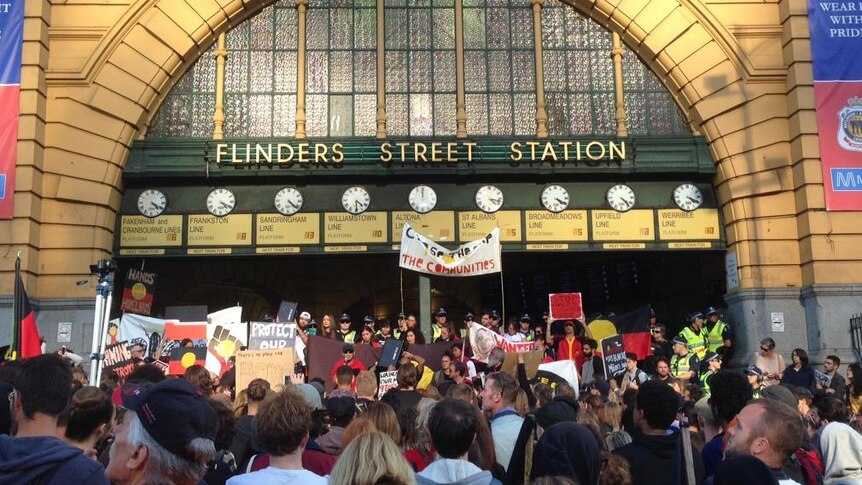 Protesters outside Flinders Street station preventing Swanston Street trams access to the CBD.