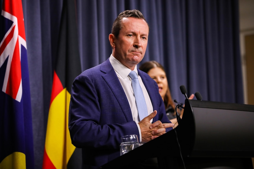 Mark McGowan standing at a lectern during a press conference.
