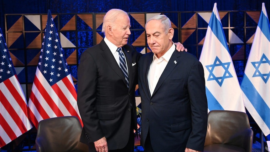 US President Joe Biden and Prime Minister Benjamin Netanyahu embrace with sober expressions