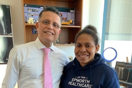 Sonia Paua and Minoo Patel pose for a photo in his office.  