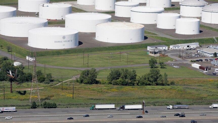 Traffic on I-95 passes oil storage tanks owned by the Colonial Pipeline Company in Linden.